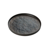A round, shallow black melamine tray from the Lunara Collection by TableCraft Products, featuring slightly raised edges and a textured, uneven surface resembling hammered metal. The tray sits on a plain white background with no other objects present.