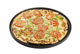 A whole vegetable pizza on a black round serving tray, sliced into pieces. The thin-crust pizza features tomato slices, green bell peppers, onions, cheese, and bits of garlic or breadcrumbs, all set against a white background.