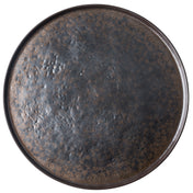 A round serving platter seen from above, featuring a dark, matte glaze with a speckled brown and black textured pattern. The edges are slightly raised, and the organic, rustic design gives this piece an uneven, artisanal finish.