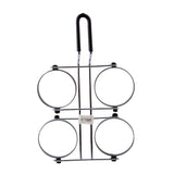 A metal milk bottle carrier with a black handle and four circular holders arranged in a square pattern, resembling non-stick egg rings. The carrier is designed to hold four bottles, with a barcode label on the center crossbar. The background is white.