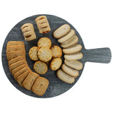 A round, gray serving paddle from the Smokehouse Melamine Collection holds an assortment of cookies: rectangular brown biscuits, swirled golden rounds, pastries with fruit filling, and oval light cookies, all neatly arranged in groups.