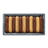 A rectangular melamine tray holds twelve long, ridged cookies, arranged in alternating rows of golden brown and chocolate brown, neatly lined up in parallel on a white background. Perfect for serving on TableCraft Products.