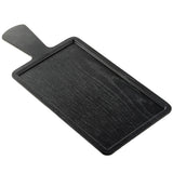 A black rectangular Serving Paddle from the Onyx Melamine Collection features a raised edge and short handle, shown on a white background. The subtle wood grain adds elegance, with the board angled and its handle pointing to the upper left.