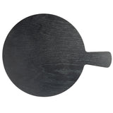 A round, black serving paddle with a short handle extends to the right. Visible wood grain patterns and a matte finish evoke the Onyx Melamine Collection, while a plain white background highlights the board’s simple, modern design.