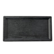A rectangular black tray, such as the TableCraft 12457 Onyx Melamine Serving Tray, features a subtle wood grain texture, raised edges, and a smooth matte finish. The empty tray is photographed from above against a white background.