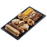 A rectangular black melamine tray displays assorted baked goods: layered cookies, triangular scones, two cinnamon rolls, a yellow bar, a brownie, and a coconut-topped bar, all neatly arranged on a white background.