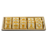 A serving tray from the Timber Melamine Collection holds twelve square crackers, each with chess piece symbols—castle, knight, queen, king, pawn, and bishop—embossed on their golden surfaces in two neat rows.