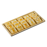 A TableCraft serving tray from the Timber Melamine Collection holds fifteen rectangular cookies, each with a unique embossed design—crowns, castles, stars, and festive symbols—arranged neatly in three rows with golden-brown edges and pale centers.