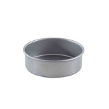 A round, non-stick silver metal cake pan with straight sides, a flat base, and a smooth, shiny finish is shown empty against a plain white background.