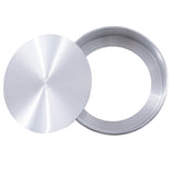 A round aluminum cheesecake pan by TableCraft is shown with a smooth, shiny finish. Its flat, circular lid rests diagonally on top, revealing the empty interior of the silver metal pan.