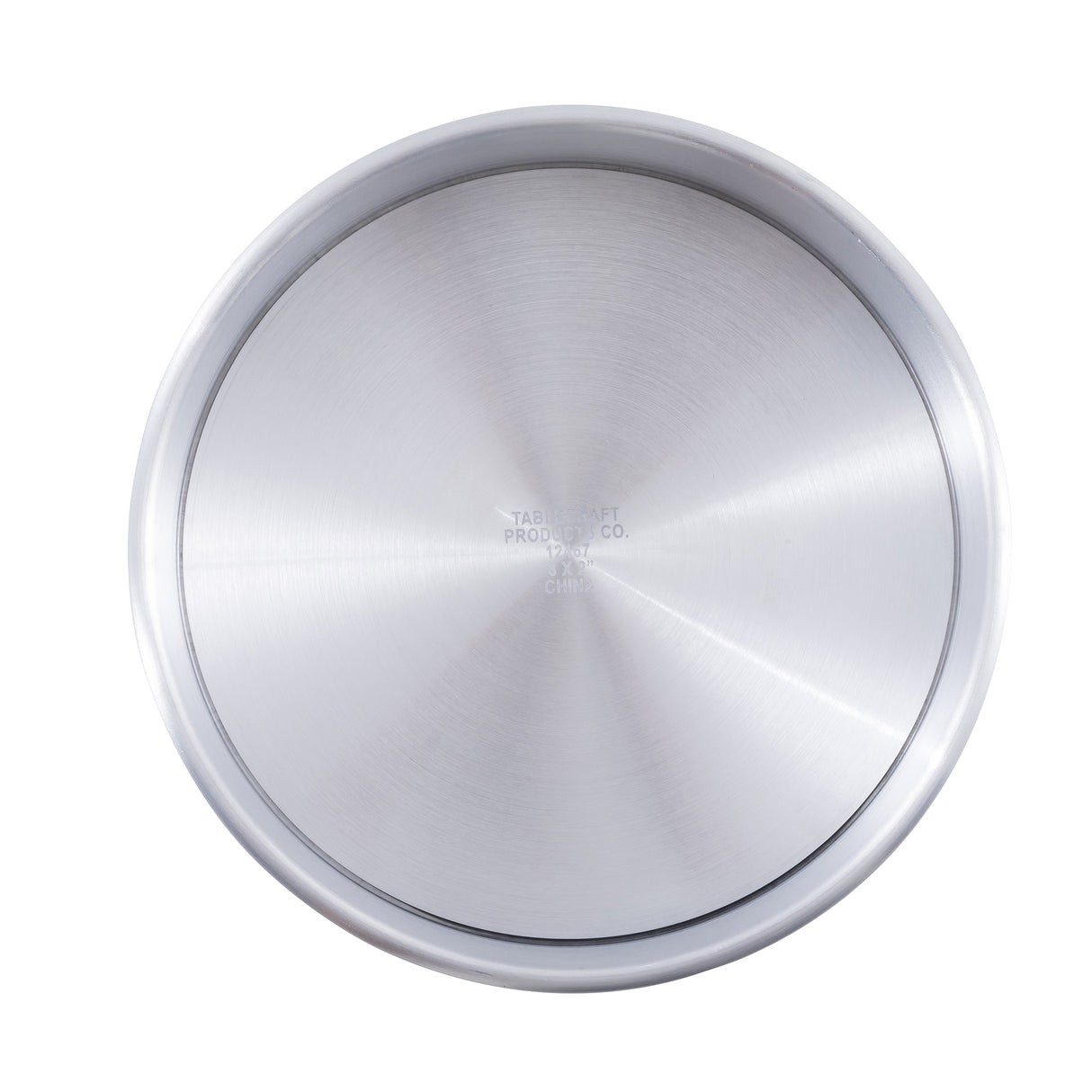 A round aluminum pan with a smooth, brushed finish and slightly raised rim is shown from above. Subtle, faint text—possibly the TableCraft logo—is visible at the center. The plain white background highlights this sleek cheesecake pan.
