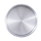 A round aluminum pan with a smooth, brushed finish and slightly raised rim is shown from above. Subtle, faint text—possibly the TableCraft logo—is visible at the center. The plain white background highlights this sleek cheesecake pan.