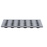 A 24 cup mini muffin pan with silicone glazed non-stick coating features 24 round molds in a 4-by-6 grid. The smooth surface and evenly spaced molds are shown from a low, side angle against a white background.