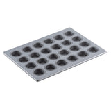 A 24 cup silicone glazed non-stick mini muffin pan with round wells for baking cupcakes or muffins, shown on a white background and viewed from an angle. The rectangular pan features a smooth, shiny surface.