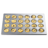 A 24 cup mini muffin pan with a silicone glazed non-stick finish is filled with unbaked crumb-topped muffin batter, visible dark chocolate chips or fruit pieces in each round cavity, isolated on a white background.