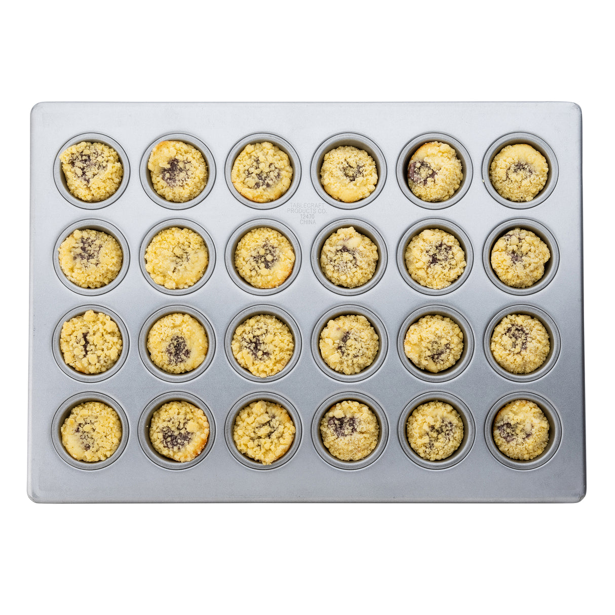 A top-down view of a 24 cup silicone glazed non-stick mini muffin pan holds golden mini muffins, each with a crumb topping and dark center—possibly chocolate or fruit. The clean pan is evenly filled for perfect baking results.