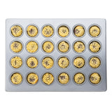 A top-down view of a 24 cup silicone glazed non-stick mini muffin pan holds golden mini muffins, each with a crumb topping and dark center—possibly chocolate or fruit. The clean pan is evenly filled for perfect baking results.