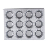 A clean, silver muffin pan with a non-stick surface, featuring twelve round cups in a 3 by 4 grid. The pan is empty and viewed from above against a white background.