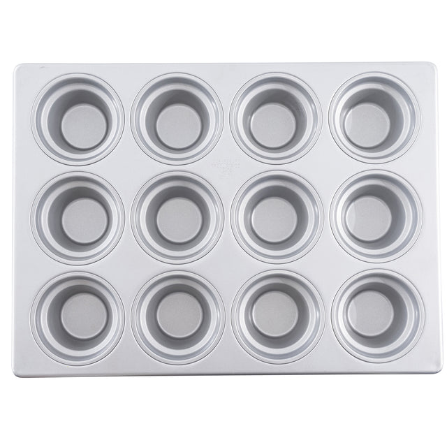 A silver 12 cup muffin pan with a silicone glazed non-stick coating is shown from above. The pan has three rows of four evenly spaced round wells, each with a circular base and smooth sides, on a flat rectangular metal tray.