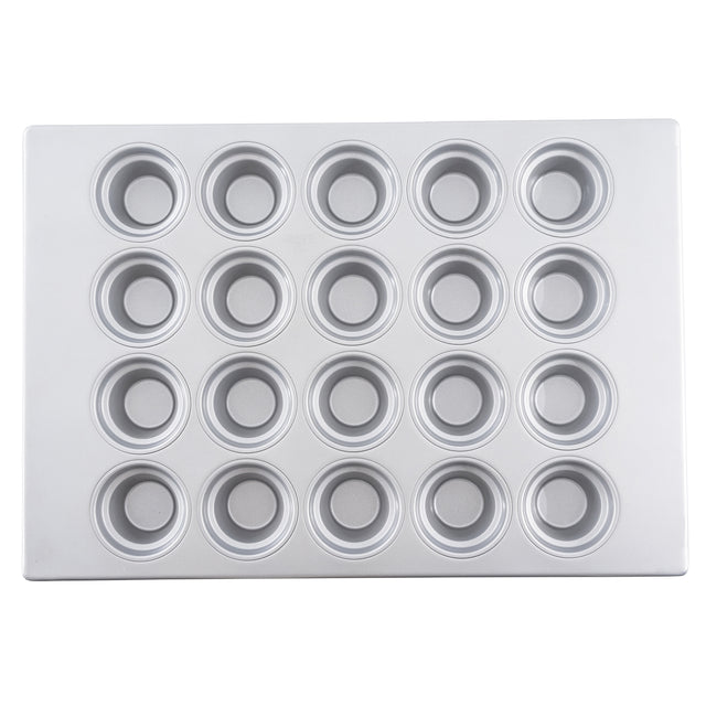 A silver metal muffin or cupcake pan is shown from above, featuring 24 round, evenly spaced cups arranged in a 4 by 6 grid. This silicone glazed non-stick pan has a smooth, shiny finish with slightly raised edges around each cup.