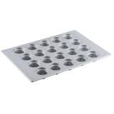 A silver silicone glazed non-stick mini muffin pan with 24 round wells arranged in a 4 by 6 grid, designed for baking small cupcakes or muffins; the pan is angled on a white background.
