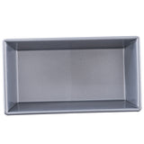 A rectangular, silver aluminized steel bread pan is viewed from above; its smooth, nonstick interior and slightly angled sides are clearly visible. The pan is clean and empty, placed against a plain white background.