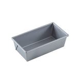 A rectangular, silver aluminized steel bread pan with straight sides and slightly rounded edges is shown on a white background. The empty non-stick bread pan is angled to display its depth and smooth, easy-to-clean interior surface.
