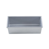 A rectangular, silver-colored aluminized steel bread pan is seen from the side on a white background. The pan has straight sides, a flat bottom, and slightly rounded corners. Its smooth, non-stick interior is perfect for baking bread, cakes, or meatloaf.