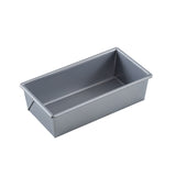 A rectangular, silver aluminized steel bread pan with straight sides and slightly rounded edges is shown from an angle on a white background. The loaf bread pan is empty and features a smooth, non-stick surface.