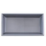 A top-down view of a rectangular, metallic loaf bread pan with straight sides and a smooth, shiny surface. The interior, made from aluminized steel, appears clean and unlined, with sharp corners and no visible markings or handles.