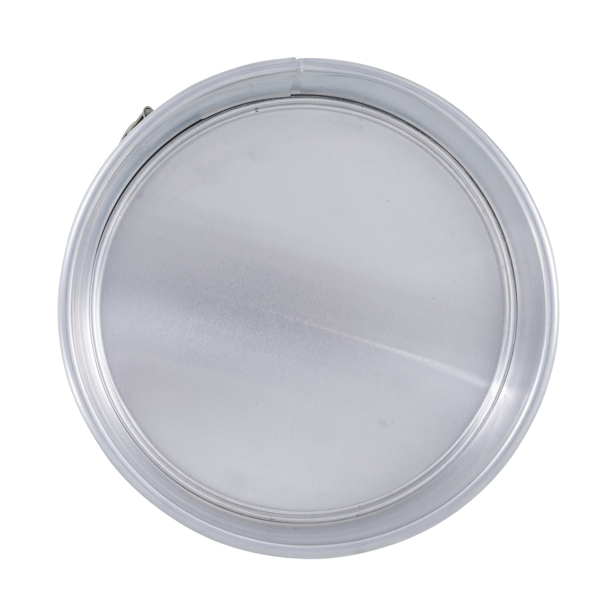 A round, closed, silver metal lid—resembling one from a springform pan—is viewed from above against a white background. The smooth, shiny surface reflects light and is bordered by a raised rim. The image is centered and evenly lit with no visible text.