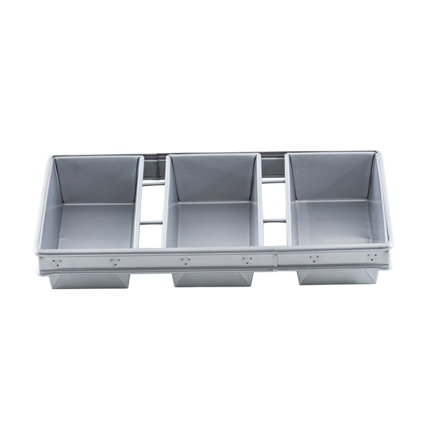 A rectangular aluminized steel bread pan divided into four equal sections, each forming a separate loaf compartment. The silver pan features straight, smooth sides, a slightly raised outer rim, and a plain white background.