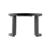 A black, round, elevated plastic riser with four vertical legs and open sides, viewed directly from the front against a white background. The simple, modern TableCraft design creates a minimalist appearance.
