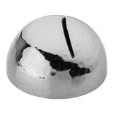 A shiny, stainless steel dome-shaped metal object with a silver hammered pattern and a single narrow slit on top, resembling a modern, minimalist coin bank or sculptural money box. The surface reflects light and surroundings.