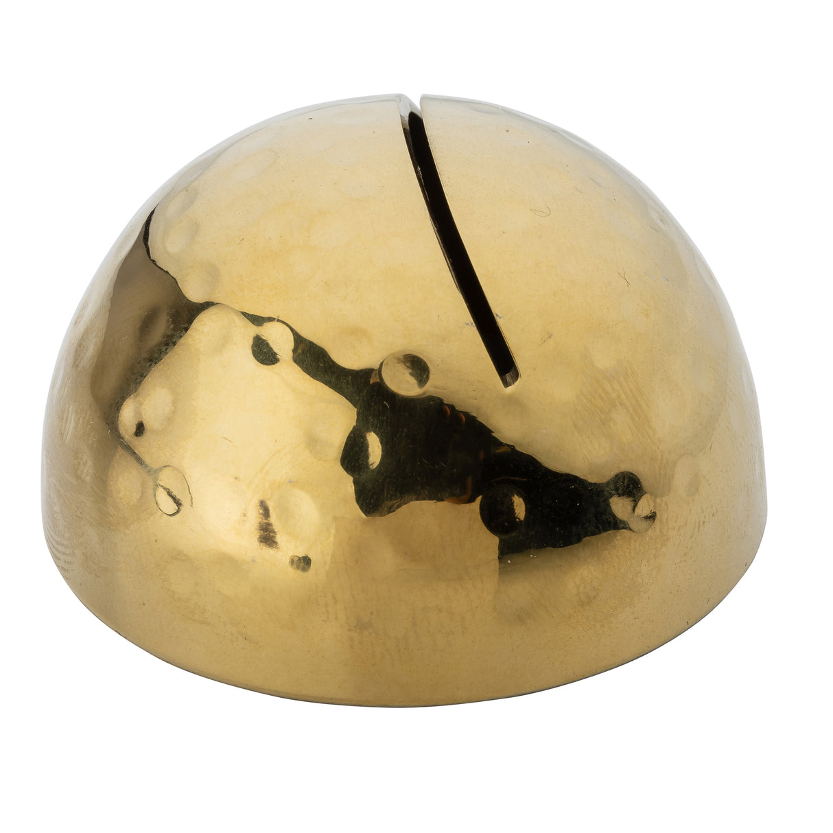 A shiny, hammered brass dome with a hammered pattern and a single narrow slot on top, resembling a minimalist piggy bank or decorative card holder. The surface reflects light with an uneven, dimpled texture, and the slot runs front to back.