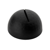 A dome-shaped, matte black card holder with a narrow slit on top. The surface features a slightly hammered pattern, finished in black powder coated texture. Photographed against a plain white background, its purpose remains ambiguous.