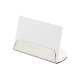 A blank white card is held upright in a sleek TableCraft Half Moon Card Holder with a reflective, stainless steel finish and minimalist design, positioned on a plain white background.
