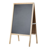 A wooden-framed, double-sided A-frame stand chalkboard stands open on a white background. The light-colored wood frame supports a blank, dark surface—perfect for writing or drawing. Metal hinges connect the panels at the top.