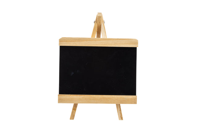 A small tabletop board sign with a blank black chalkboard surface and light wood trim stands on a matching wooden easel against a plain white background. Simple and minimalistic, it's ready for your notes or drawings.
