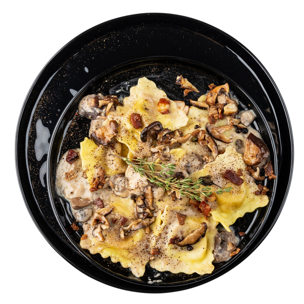 A black melamine serving plate holds square ravioli topped with creamy mushroom sauce, sautéed mushrooms, crispy bits, and thyme. Black pepper speckles the sauce, giving the pasta a rustic, gourmet look on this elegant platter.