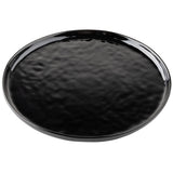 A round, black melamine plate from the TableCraft Ridge Collection features a glossy, slightly textured surface and raised edges. Light reflects off its shiny glaze, revealing a subtle, uneven pattern against the plain white background.