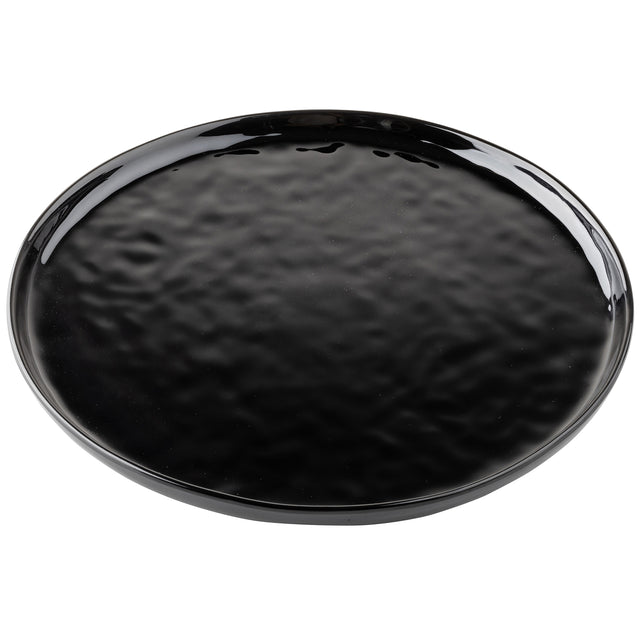 A round, black melamine plate from the TableCraft Ridge Collection features a glossy, slightly textured surface and raised edges. Light reflects off its shiny glaze, revealing a subtle, uneven pattern against the plain white background.