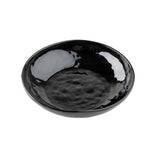 A glossy, black ceramic serving bowl from the Ridge Collection features a wide, shallow shape and a slightly irregular, textured surface. The reflective glaze creates striking patches of light on both the interior and exterior.