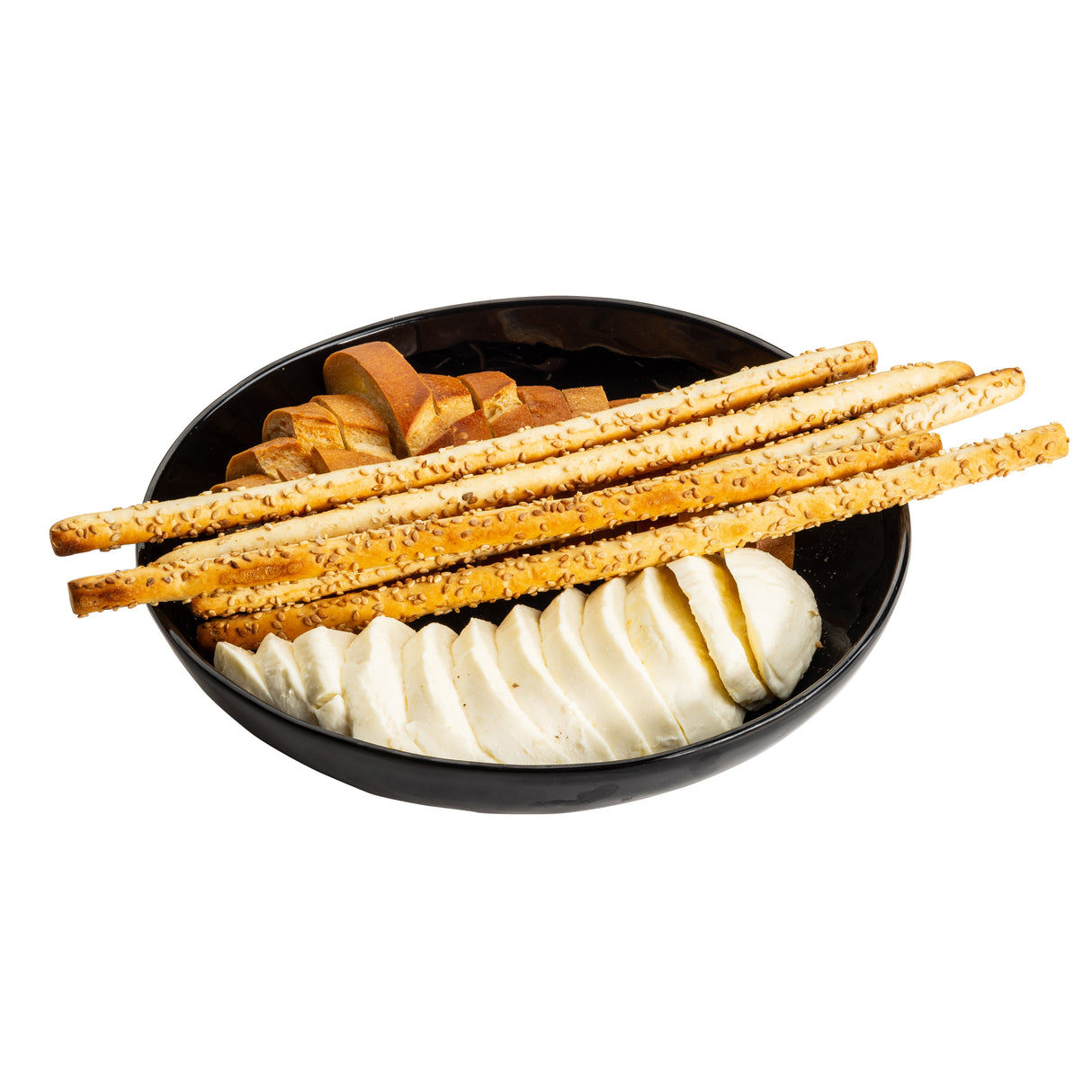 A black Melamine Serving Bowl from the Ridge Collection contains several thin breadsticks, round slices of white cheese, and a swirl of brown bread, all arranged neatly and isolated on a white background.