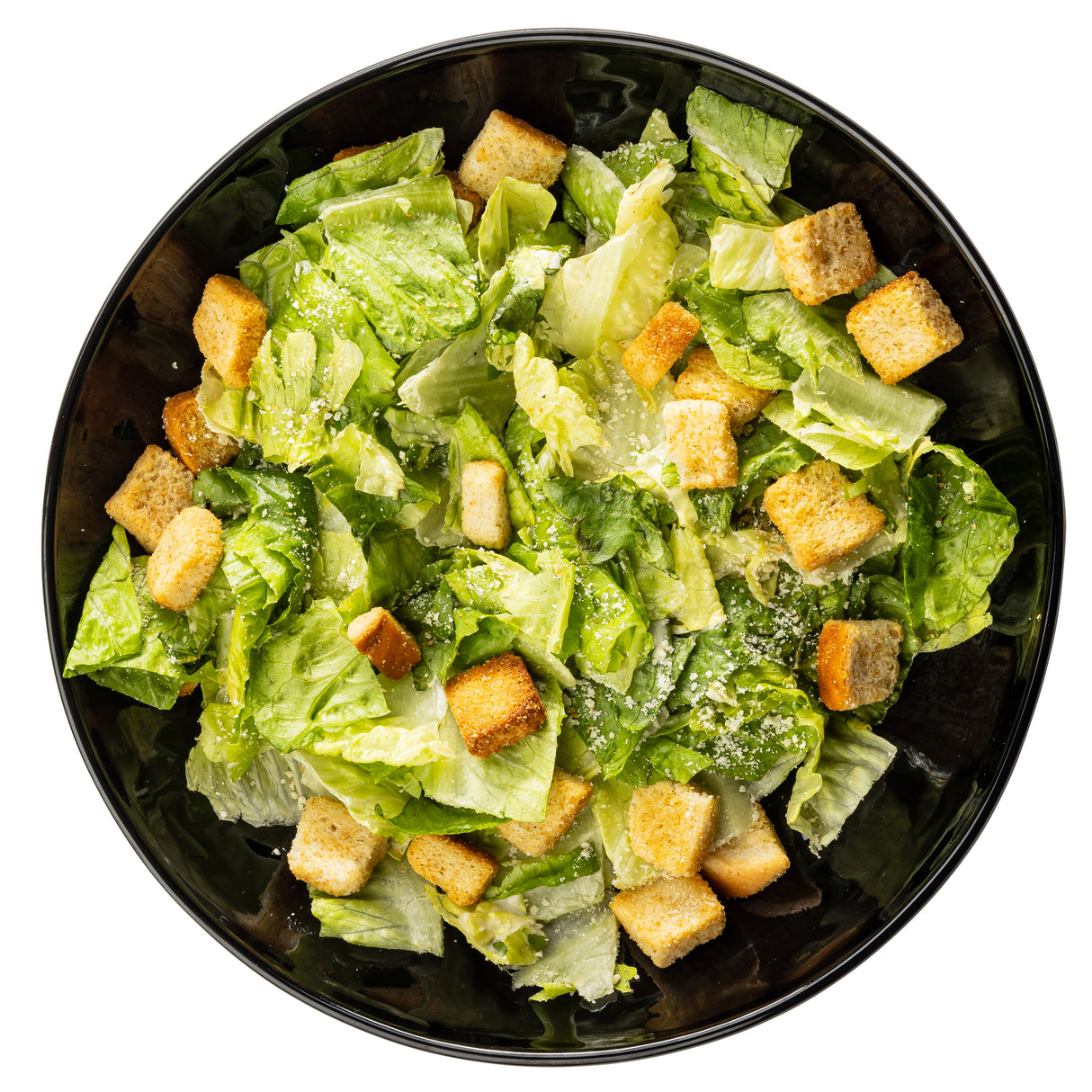 A black melamine serving bowl filled with Caesar salad, featuring chopped romaine lettuce, golden brown croutons, and a sprinkle of grated Parmesan cheese, all arranged neatly on a white background.