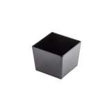 A small, empty, black TableCraft melamine bowl is centered on a white background. The bowl features smooth sides and an open top, revealing its dark interior. Subtle highlights accentuate the edges under the lighting.