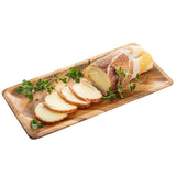 A rectangular Acacia serving plate holds several slices of smoked cheese wrapped in prosciutto, garnished with fresh green herbs, all arranged neatly on a white background.