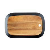 A rectangular serving board from the TableCraft Acacia Collection with rounded edges, a smooth surface, and a small circular hole in one corner. The thick black outer rim adds a modern touch against the plain white background.