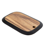 A rectangular serving board with rounded corners and a black edge border. Crafted from natural wood with a distinct grain pattern, this piece—part of the TableCraft Acacia Collection—features a small circular hole for hanging or easy handling.