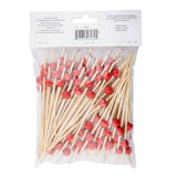 A clear plastic bag contains many TableCraft 12582 bamboo ball picks, each topped with a small red bead. The bag has a white label at the top with printed product details, storage instructions, warnings, and manufacturer’s information.